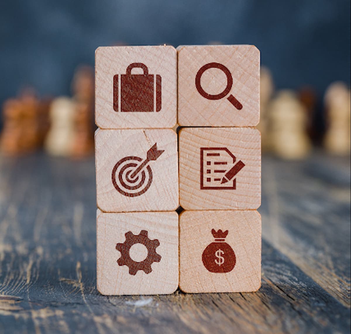 Wooden blocks with business icons representing the strategic value of consumer testing in product development